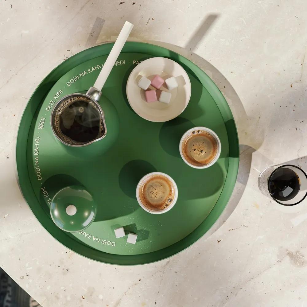 Top view of the džezva full of coffee next to two fildžani
